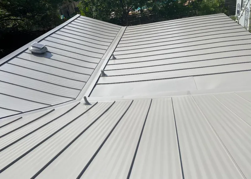 Solar attic fan installed on a metal roof for Roof Ventilation in Dranesville